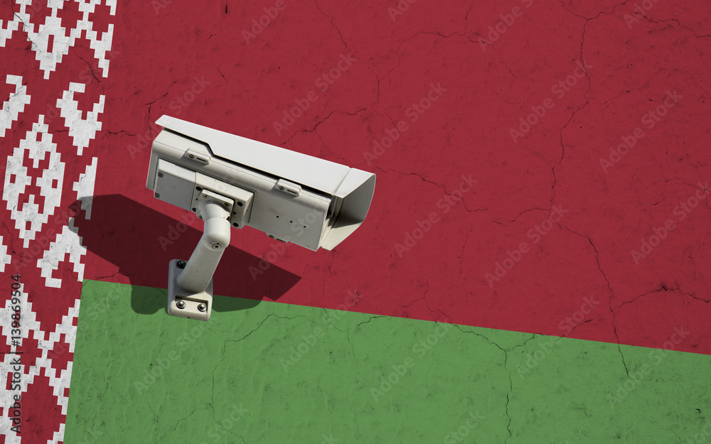 Belarus flag on wall with CCTV surveillance security camera Belarus flag on wall with CCTV surveillance security camera