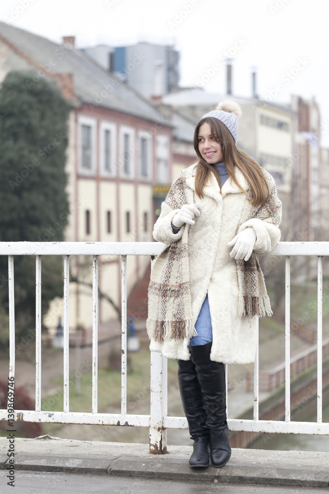 Fototapeta premium Beautiful young woman on the bridge