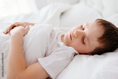Little boy child sleeping in bed