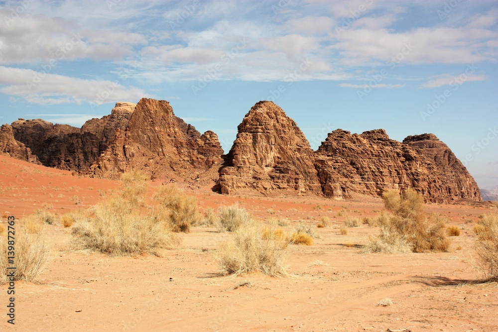 Bizarre rock walls consisting of sandstone and granite in desert valley of Wadi Rum in Jordan