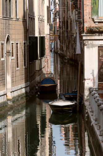 Narrow channel with two boats in Venice © phokrates