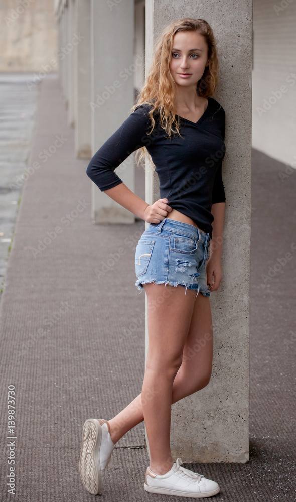 Pretty Teen in Black Top and Jean Shorts Outside Photos | Adobe Stock