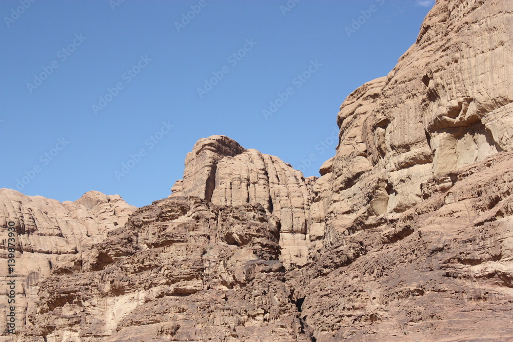 Bizarre rock walls consisting of sandstone and granite in desert valley of Wadi Rum in Jordan