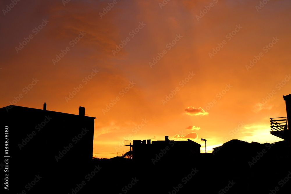 Beautiful sunset in a city, building silhouettes and vibrant sky. 