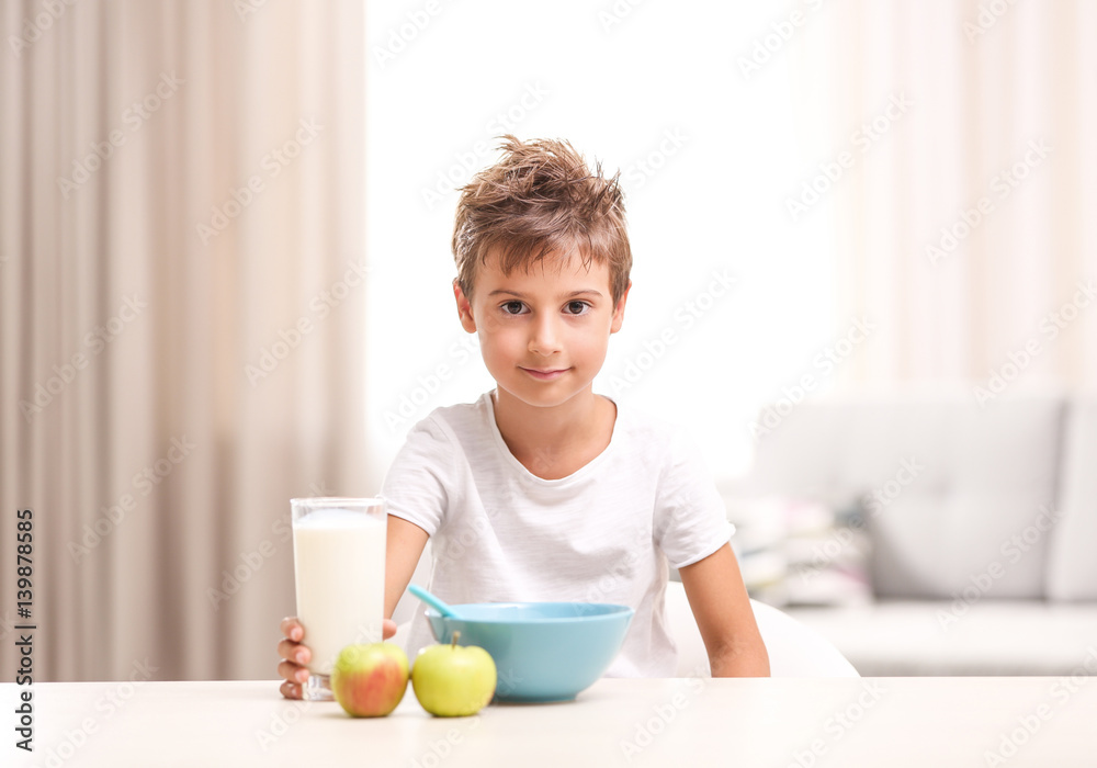 Cute kid having healthy breakfast in the room Cute kid having healthy breakfast in the room