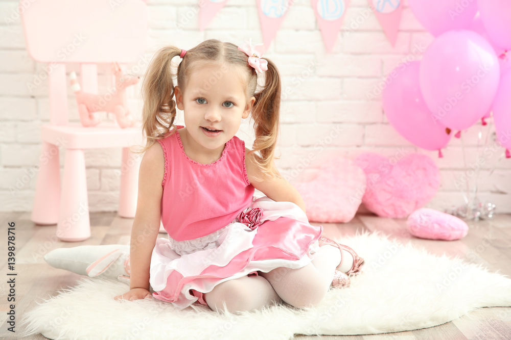 Little cute girl with party decor on brick wall background Little cute girl with party decor on brick wall background