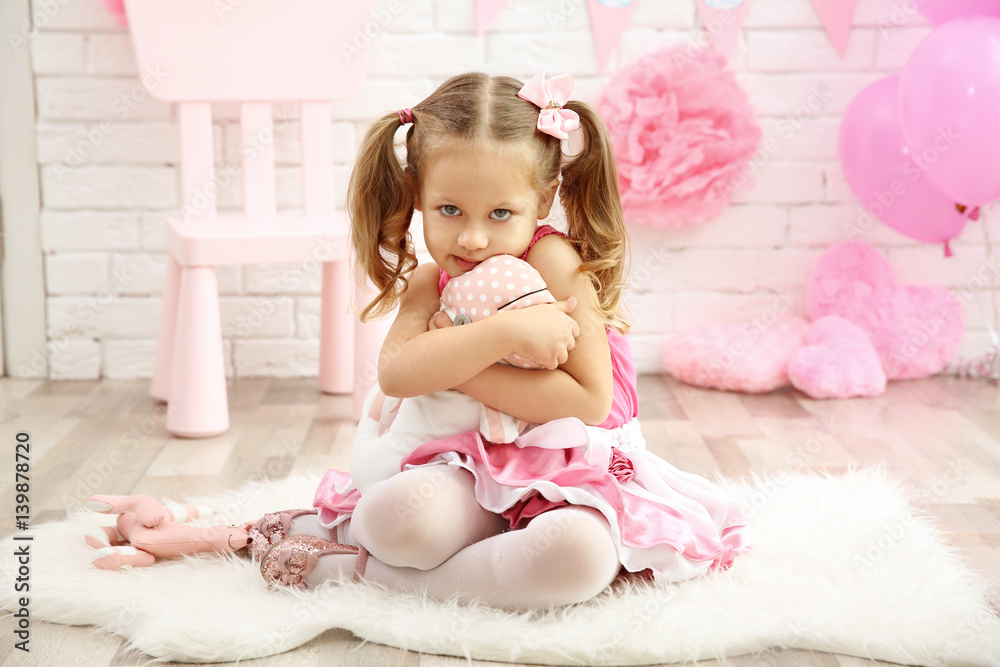 Little cute girl with party decor on brick wall background Little cute girl with party decor on brick wall background