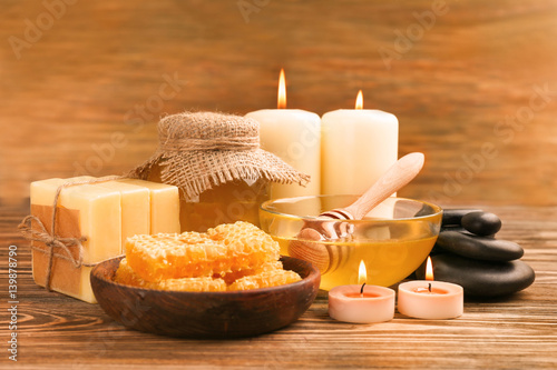 Spa composition with honey on wooden background