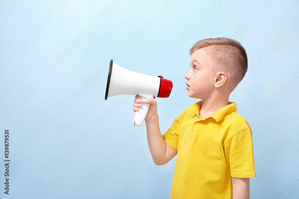 Cute little boy with megaphone on color background Cute little boy with megaphone on color background