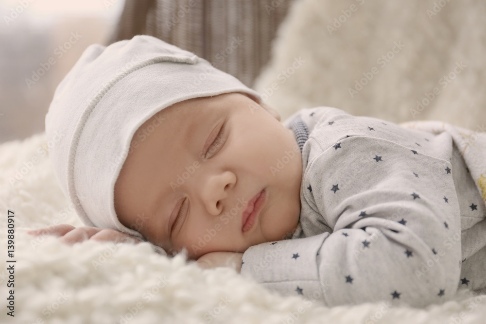Cute little baby sleeping on plaid at home, closeup Cute little baby sleeping on plaid at home, closeup