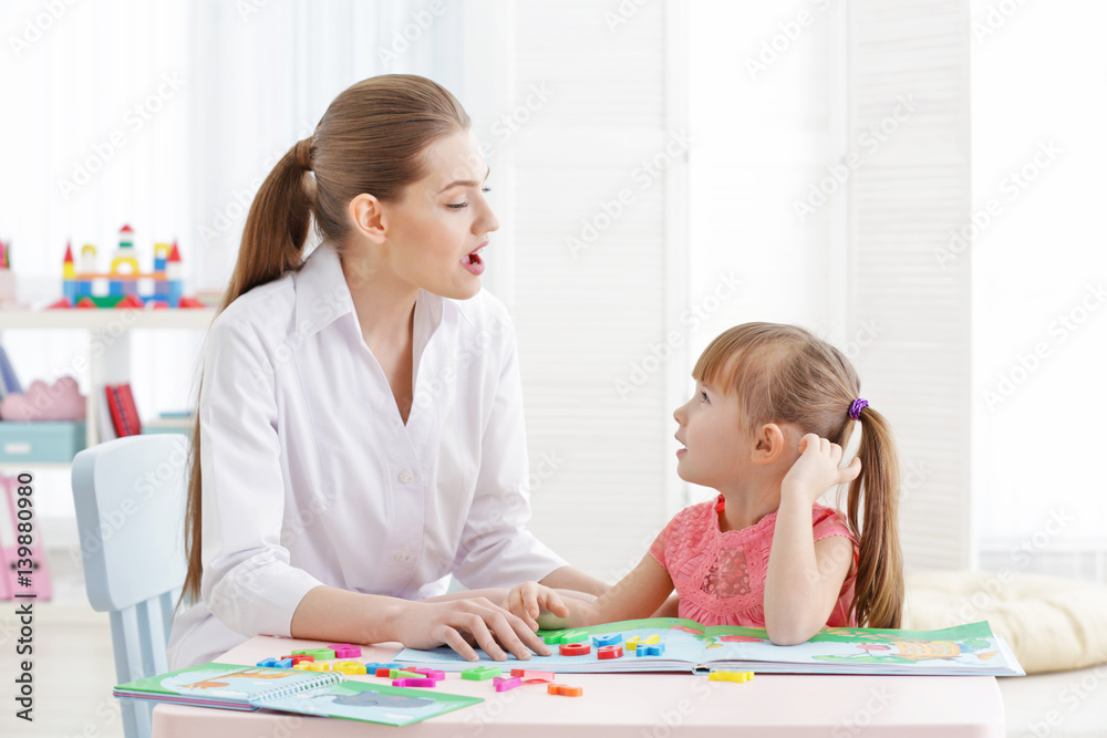 Fototapeta premium Cute little girl at speech therapist office