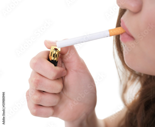 Young woman lighting cigarette  closeup