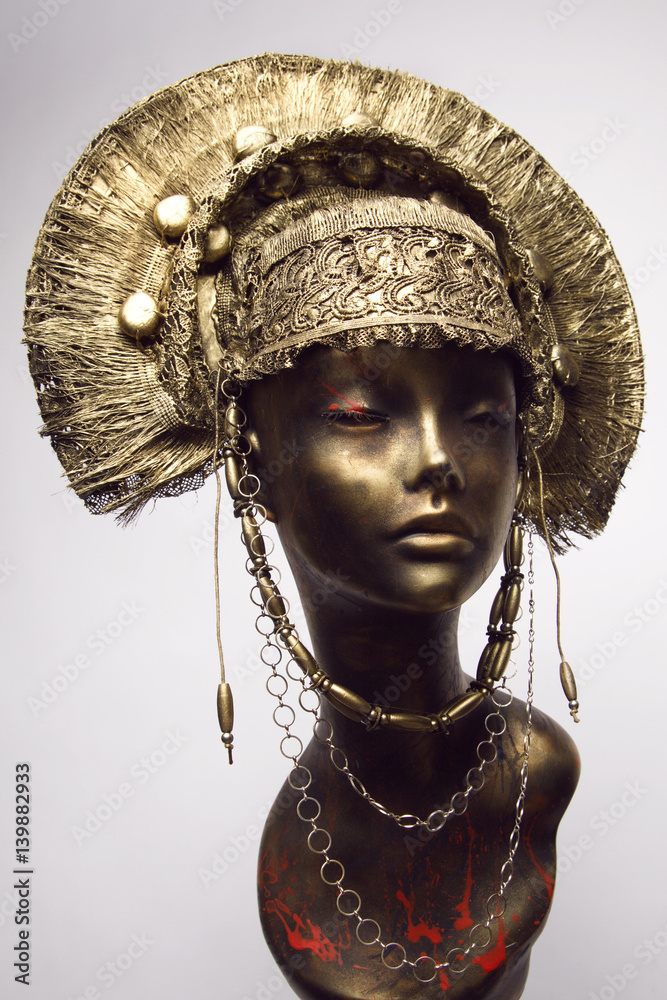 Mannequin in golden headwear