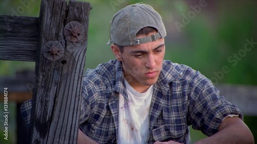 Waist-up portrait of unhappy teenage boy 