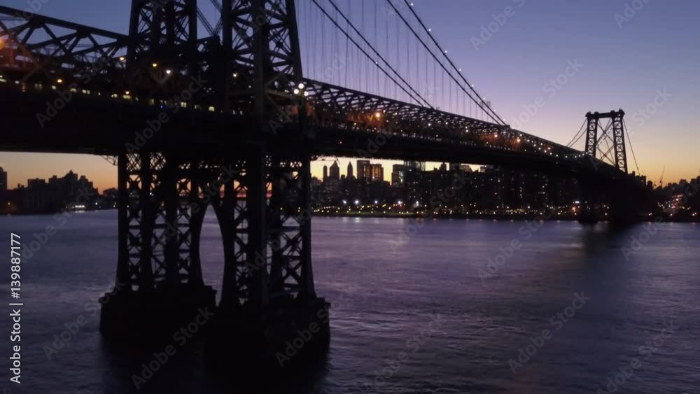 dusk rising shot of Williamsburg Bridge with Manhattan skyline in background dusk rising shot of Williamsburg Bridge with Manhattan skyline in background