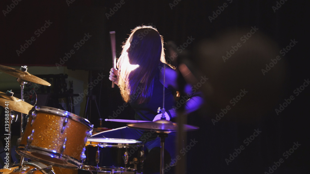 Fototapeta premium Girl rock musician - female drummer performing