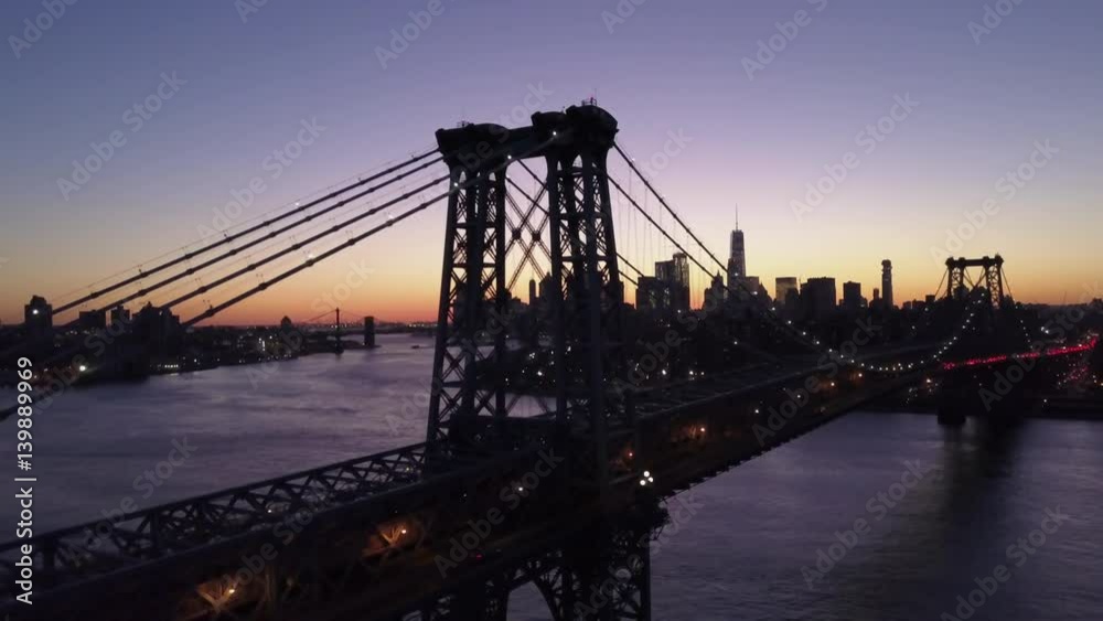 dusk flying along Williamsburg Bridge towards Manhattan skyline dusk flying along Williamsburg Bridge towards Manhattan skyline