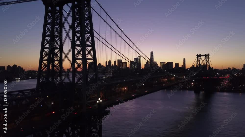 dusk descending shot of Williamsburg Bridge with Manhattan skyline in background dusk descending shot of Williamsburg Bridge with Manhattan skyline in background