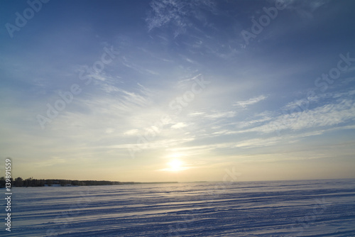 Winter landscape with a view of the setting sun