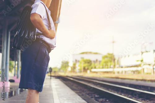 Asian student waiting train at train station.Back to school