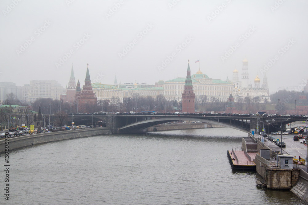 Foggy spring morning on the embankment of the river
