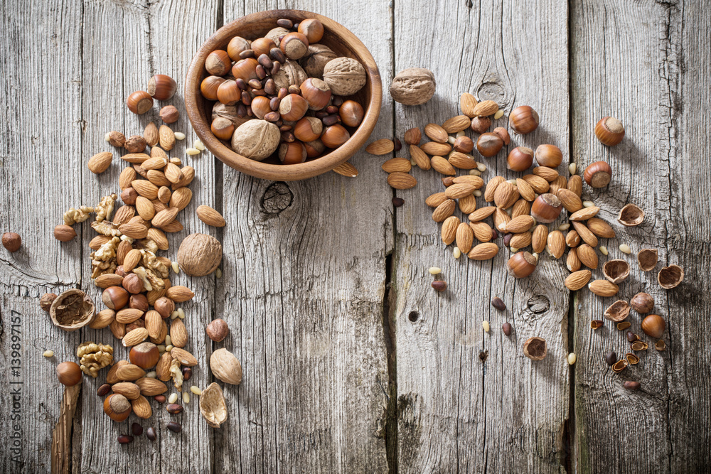 Mixed nuts on old wooden background Mixed nuts on old wooden background