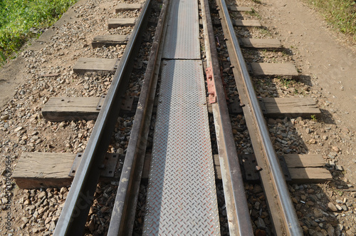 Horizontal closeup of railway lines in sunlight