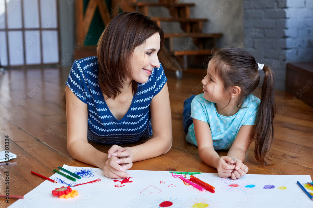 young mother teaches her daughter to draw young mother teaches her daughter to draw