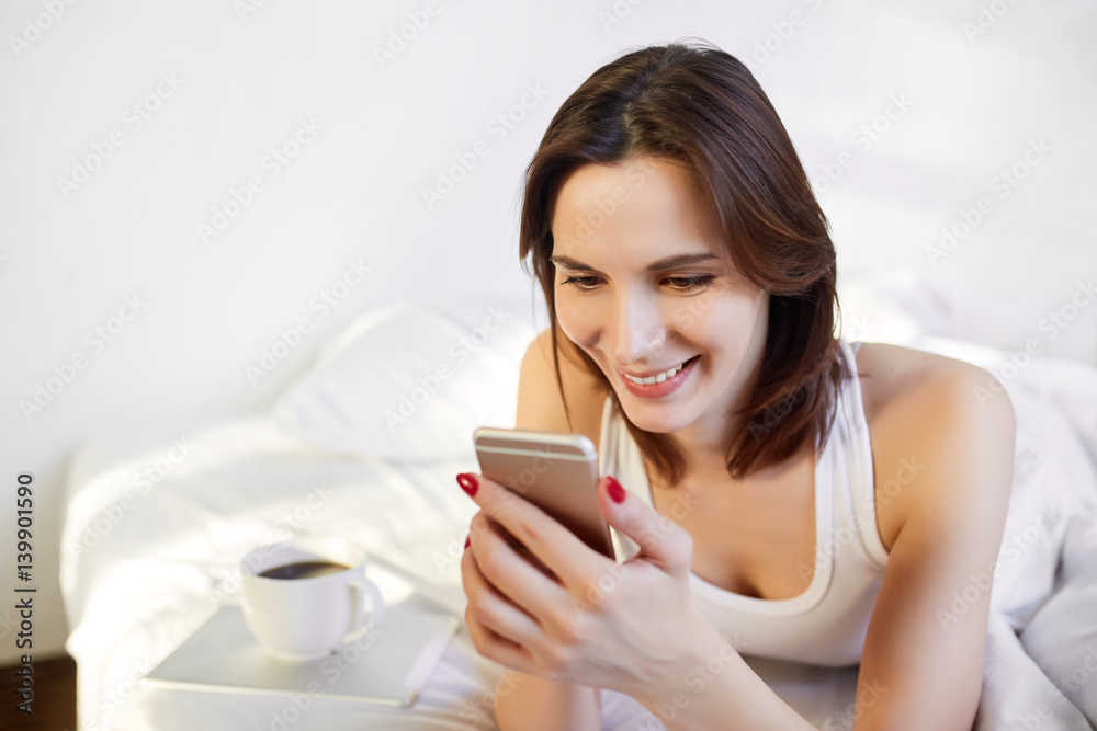 young woman writes a message on a smartphone young woman writes a message on a smartphone