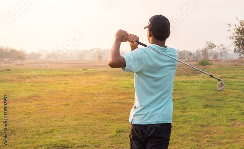 Golfer finishing his driver swing