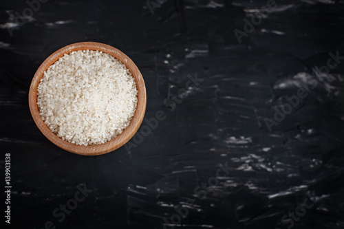 Polished rice in a wooden bowl. The concept of healthy eating and vegetarianism.
