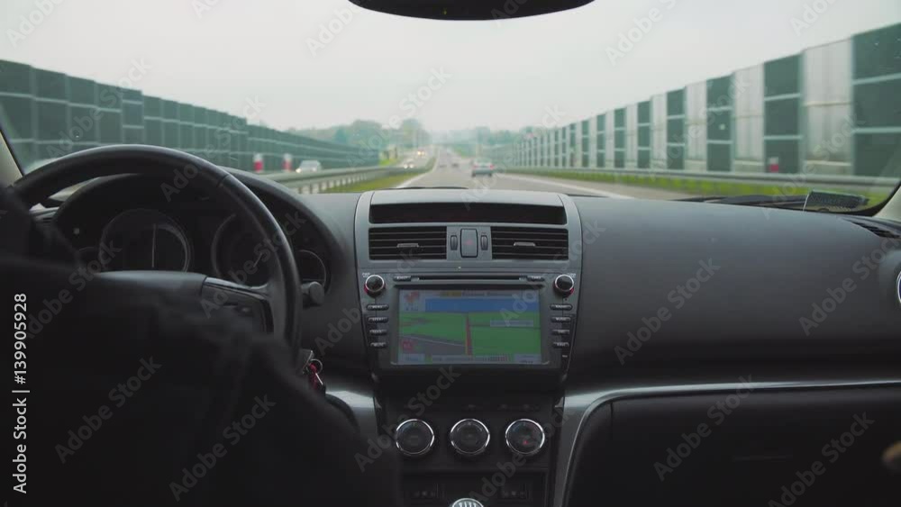 man using navigation system while driving a car