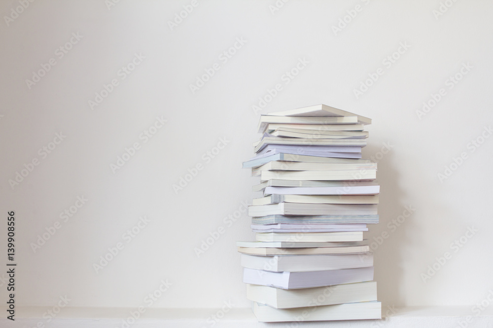 Close up book stacked with concrete wall background Close up book stacked with concrete wall background