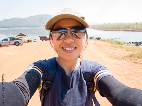 Traveler woman take picture by herself selfie Mae Ngad Dam and Reservoir Chiangmai Thailand