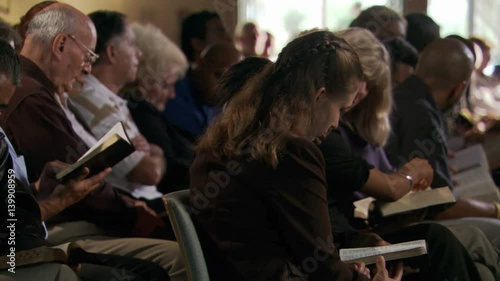 Seated congregation reading their Bibles