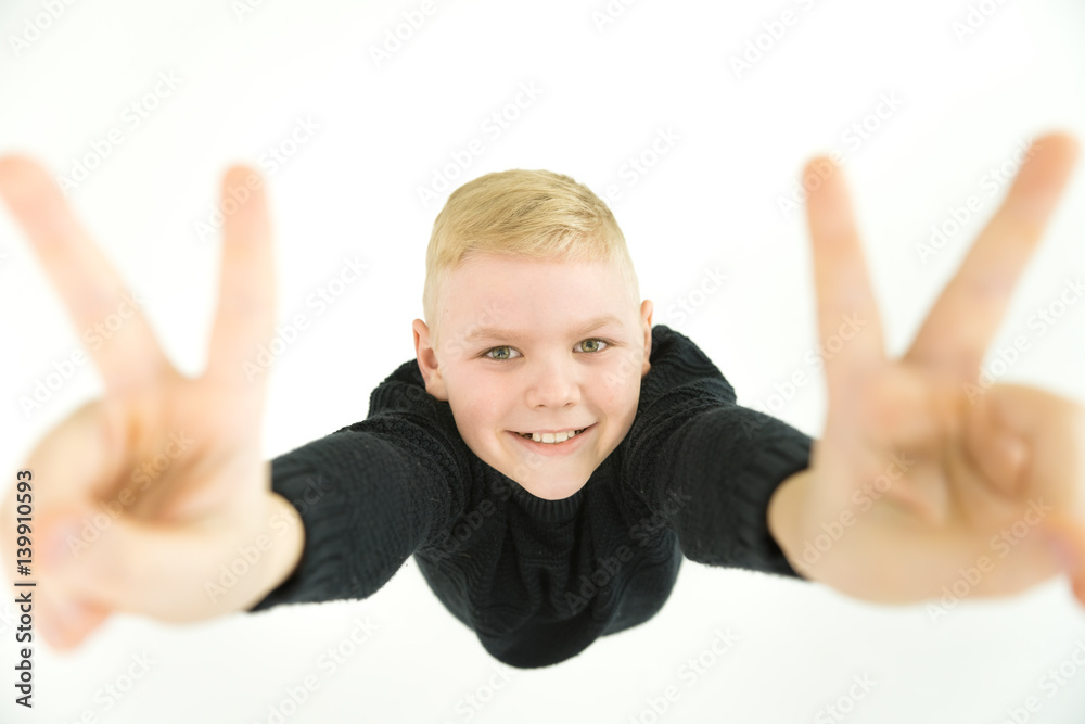 The boy gesture to the camera. View from above The boy gesture to the camera. View from above