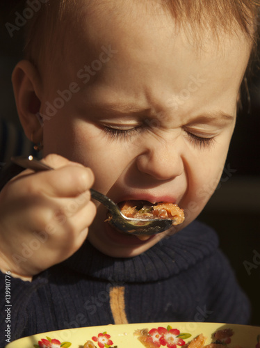 little baby girl learning to eat with a spoon © zwiebackesser