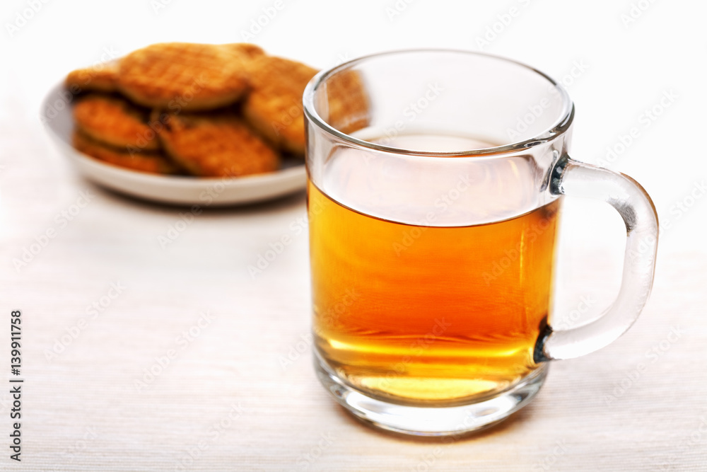 Cup of black tea and biscuits on a plate Cup of black tea and biscuits on a plate
