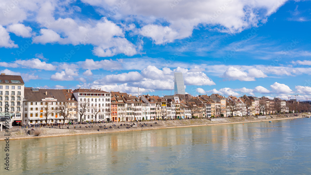The riverside of Basel, Switzerland with old medieval buildings, river Rhine and Roche tower in the background