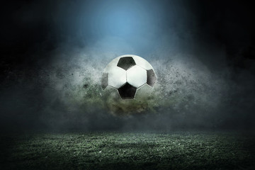 Moving soccer ball around splash drops on the stadium field.