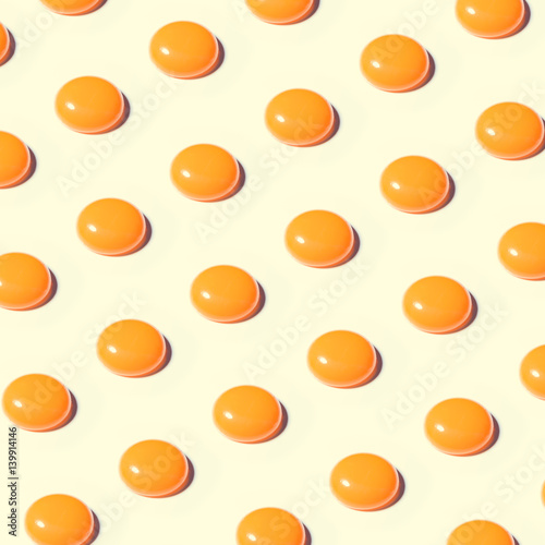 Pattern made of egg yolks on bright background. Minimal food concept.