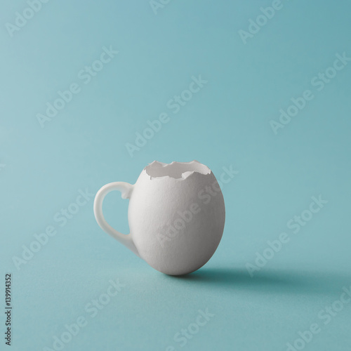 Obraz na plátně Egg shell coffee cup on pastel blue background