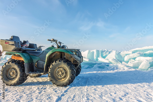 Quad bike on the ice bikala among hummocks