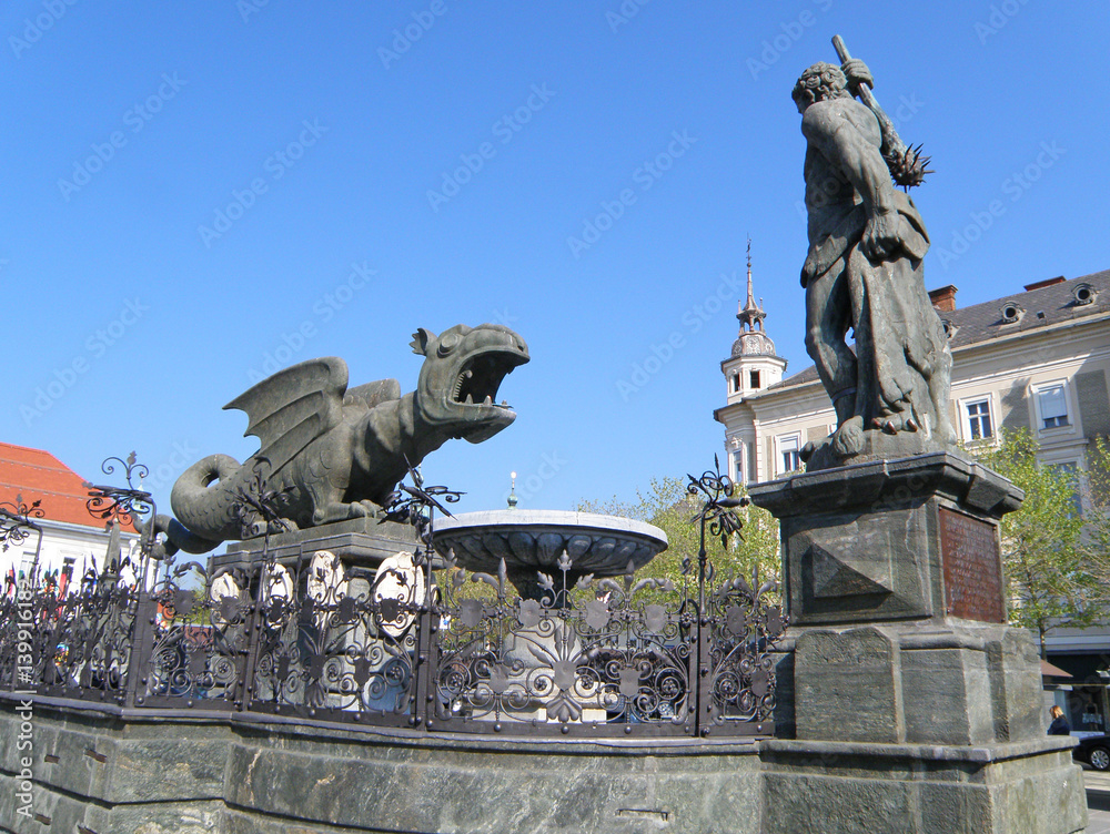 The famous landmark of Klagenfurt, medieval Dragon Fountain or the Lindwurmbrunnen, Austria 