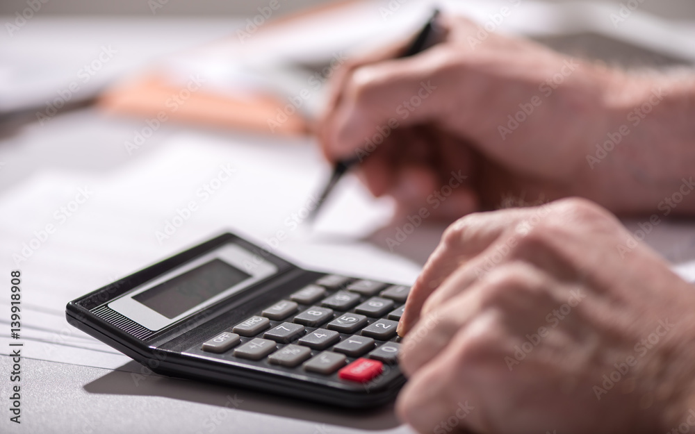 Hand using calculator, accounting concept Hand using calculator, accounting concept