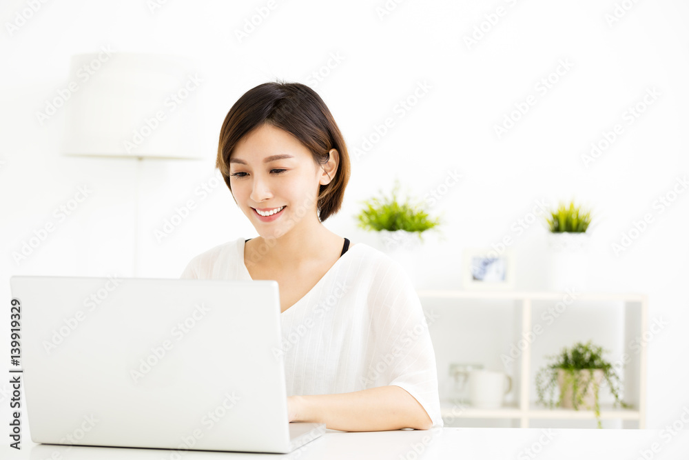 happy young woman with laptop in living room happy young woman with laptop in living room
