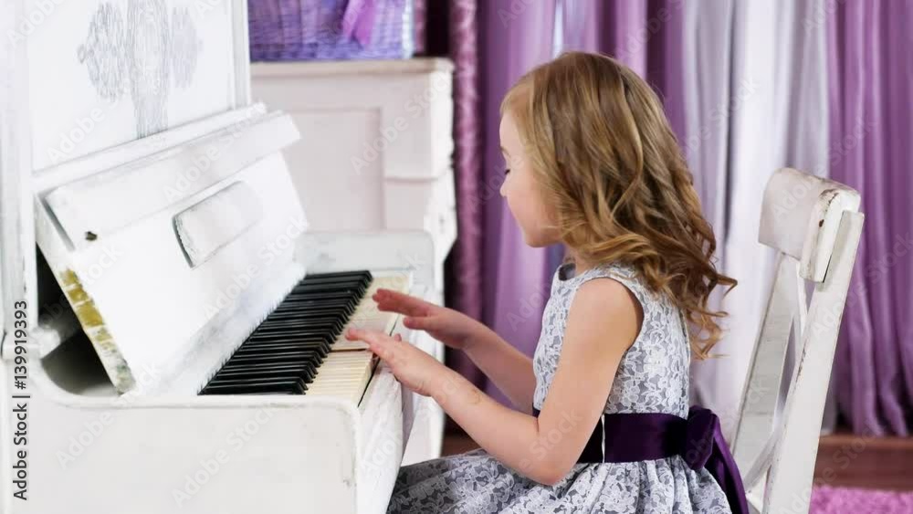little girl blonde plays piano, girl in a dress with a purple belt, 4k little girl blonde plays piano, girl in a dress with a purple belt, 4k