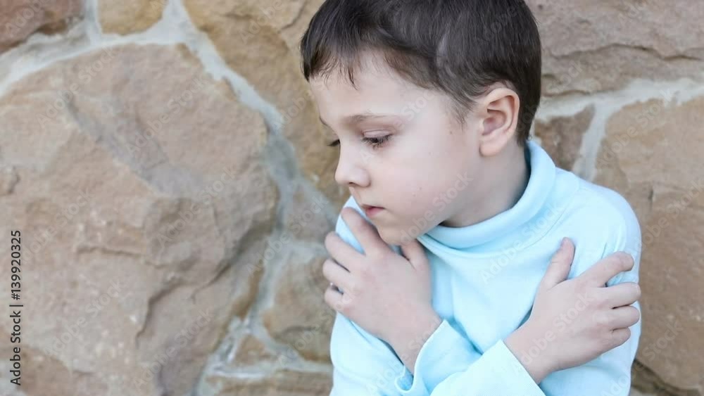sad little boy outdoors at the day time sad little boy outdoors at the day time