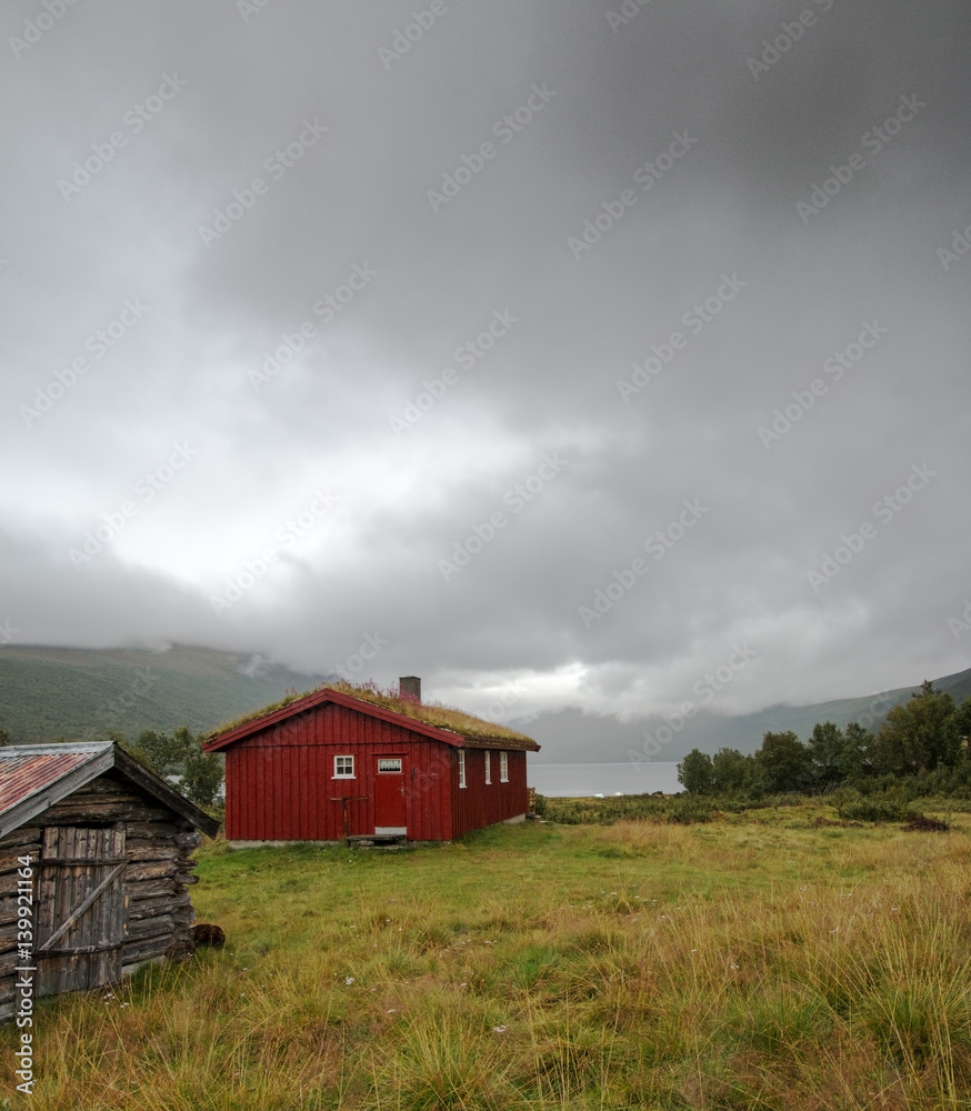 Old barn at lake Helin in Norway