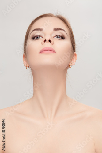 Fototapeta portrait of female neck on grey background closeup. girl with c